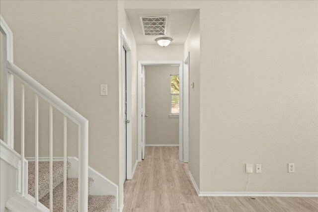 15411 Ora Ln, Pflugerville, TX 78660 - corridor with light wood-style flooring and stairs