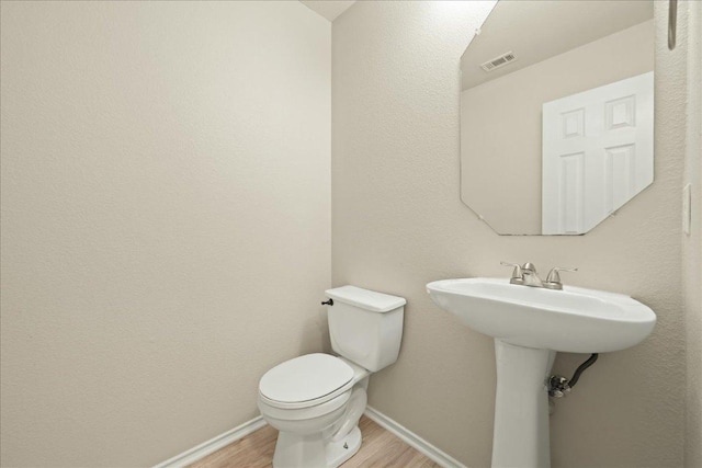 15411 Ora Ln, Pflugerville, TX 78660 - bathroom with wood finished floors and toilet