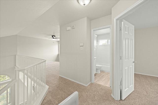 15411 Ora Ln, Pflugerville, TX 78660 - hallway with carpet floors, an upstairs landing, and baseboards