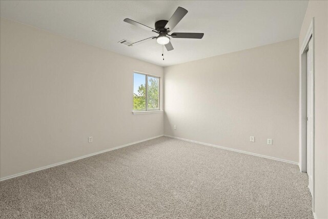 15411 Ora Ln, Pflugerville, TX 78660 - spare room featuring carpet flooring, a ceiling fan, and baseboards