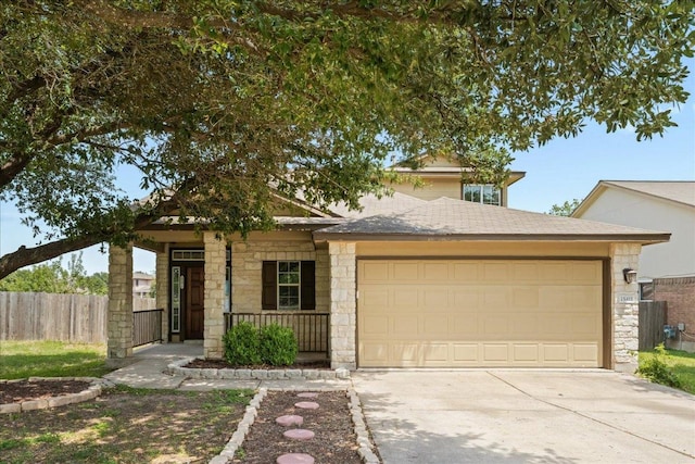 15411 Ora Ln, Pflugerville, TX 78660 - view of front facade featuring stone siding, a garage, driveway, and a porch