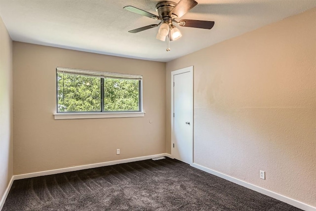 8524 Dryfield Dr, Austin, TX 78758 - spare room featuring dark colored carpet, a ceiling fan, and baseboards