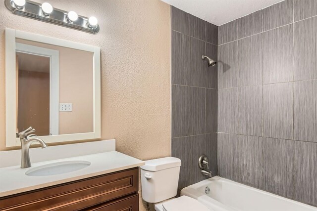 8524 Dryfield Dr, Austin, TX 78758 - full bathroom with vanity, toilet, a textured wall, and bathing tub / shower combination
