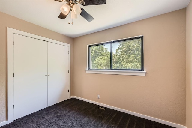 8524 Dryfield Dr, Austin, TX 78758 - unfurnished bedroom with dark carpet, a closet, baseboards, and ceiling fan