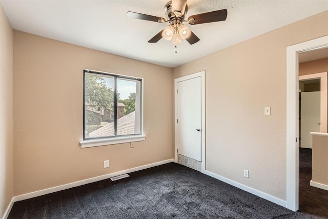 8524 Dryfield Dr, Austin, TX 78758 - unfurnished bedroom with dark colored carpet, baseboards, and ceiling fan