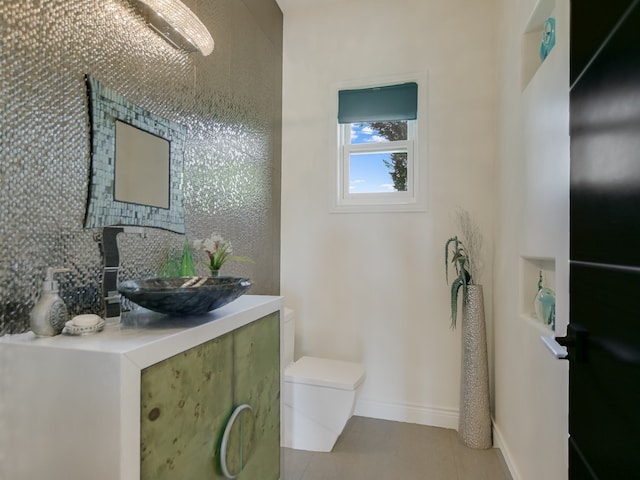 1001 Marly Way, Austin, TX 78733 - half bathroom with tasteful backsplash, toilet, tile patterned floors, vanity, and baseboards