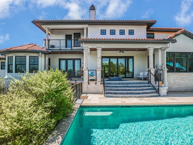 1001 Marly Way, Austin, TX 78733 - back of house featuring a balcony, stucco siding, an outdoor pool, french doors, and a patio area