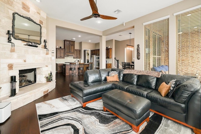 22218 W Cape Travis Bnd, Lago Vista, TX 78645 - living area with wood finished floors, a ceiling fan, and a fireplace