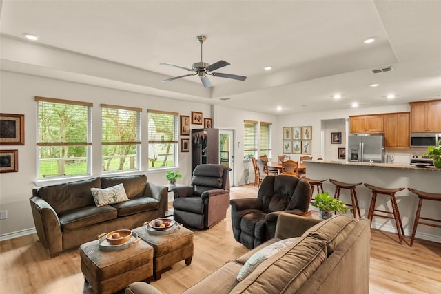 805 Willow Creek Cir, San Marcos, TX 78666 - living area featuring a tray ceiling, light wood finished floors, recessed lighting, and a ceiling fan