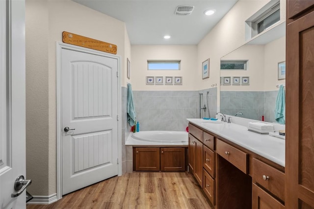 805 Willow Creek Cir, San Marcos, TX 78666 - bathroom featuring wood finished floors, a bath, and vanity