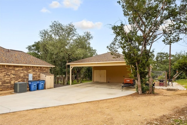 805 Willow Creek Cir, San Marcos, TX 78666 - view of vehicle parking featuring driveway, a carport, and a shed