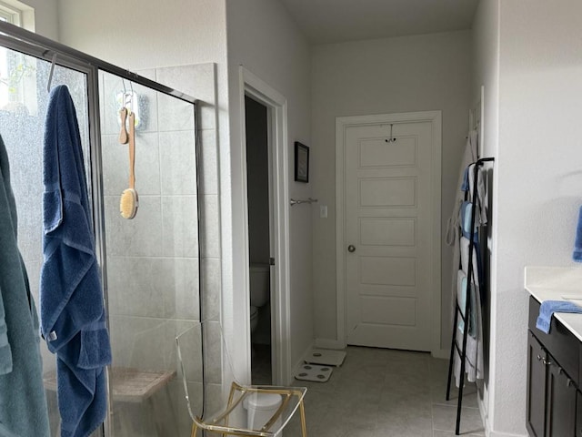 2404 Pack Iron Pass, Leander, TX 78641 - full bathroom featuring toilet, a shower stall, vanity, and tile patterned flooring
