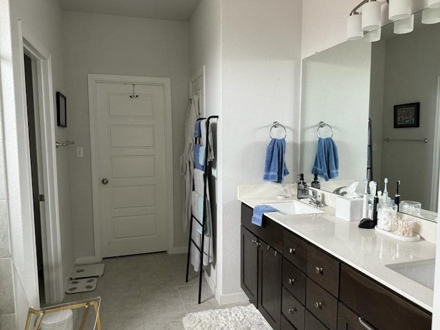 2404 Pack Iron Pass, Leander, TX 78641 - bathroom featuring double vanity, tile patterned floors, and baseboards