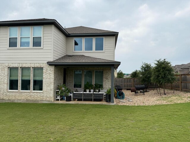 2404 Pack Iron Pass, Leander, TX 78641 - back of house with an outdoor hangout area, a patio area, brick siding, and a shingled roof