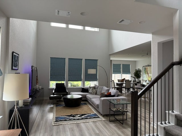 2404 Pack Iron Pass, Leander, TX 78641 - living room with wood finished floors, stairway, and a towering ceiling