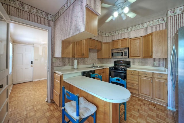 214 Beaver St, Austin, TX 78753 - kitchen featuring black appliances, wallpapered walls, a sink, a ceiling fan, and light countertops
