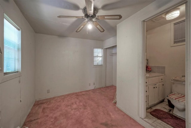 214 Beaver St, Austin, TX 78753 - unfurnished bedroom featuring light carpet, ensuite bath, and ceiling fan