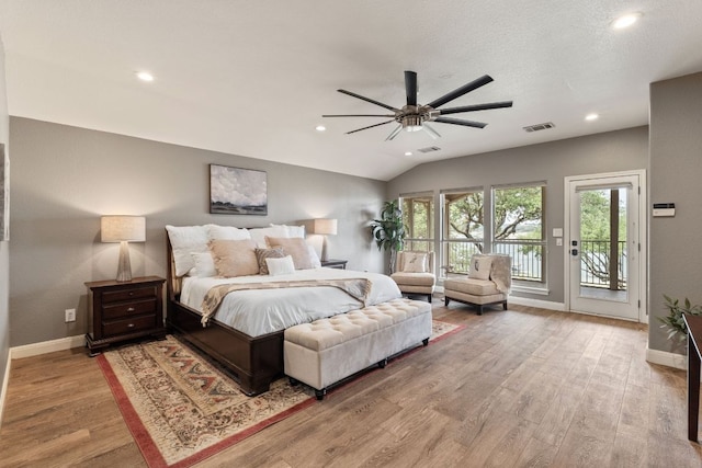212 Lakefront Dr, Point Venture, TX 78645 - bedroom with access to exterior, wood finished floors, baseboards, recessed lighting, and vaulted ceiling