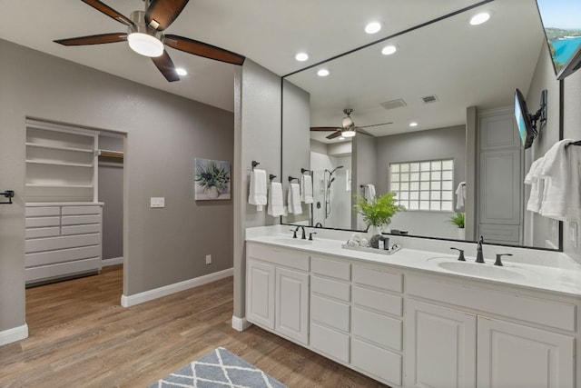 212 Lakefront Dr, Point Venture, TX 78645 - full bath featuring ceiling fan, recessed lighting, baseboards, wood finished floors, and double vanity