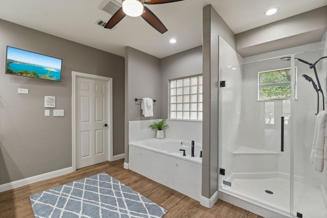 212 Lakefront Dr, Point Venture, TX 78645 - bathroom with a shower stall, a bath, wood finished floors, and a ceiling fan