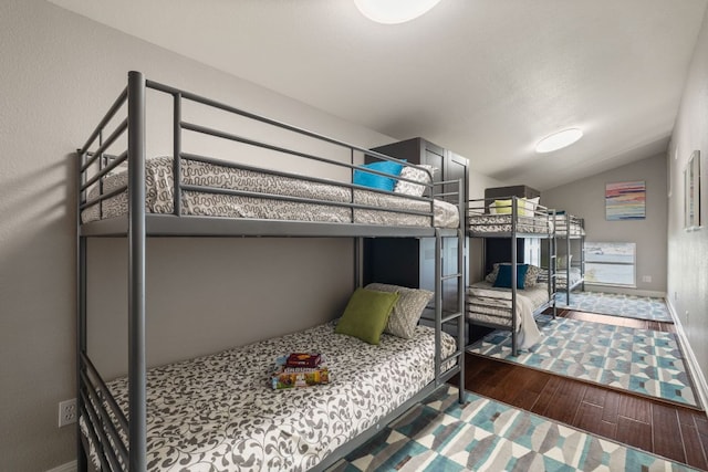 212 Lakefront Dr, Point Venture, TX 78645 - bedroom featuring wood finished floors, lofted ceiling, and baseboards