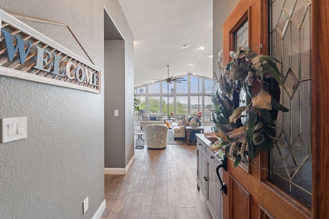 212 Lakefront Dr, Point Venture, TX 78645 - hallway featuring light wood-type flooring, vaulted ceiling, a textured wall, baseboards, and recessed lighting