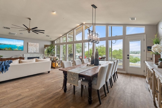 212 Lakefront Dr, Point Venture, TX 78645 - dining space featuring healthy amount of natural light, wood finished floors, high vaulted ceiling, a ceiling fan, and a chandelier