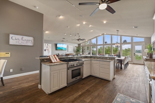 212 Lakefront Dr, Point Venture, TX 78645 - kitchen with high end stainless steel range, ceiling fan, white cabinets, dark wood finished floors, and vaulted ceiling