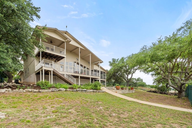 212 Lakefront Dr, Point Venture, TX 78645 - rear view of house with ceiling fan, stairway, a lawn, a balcony, and a wooden deck