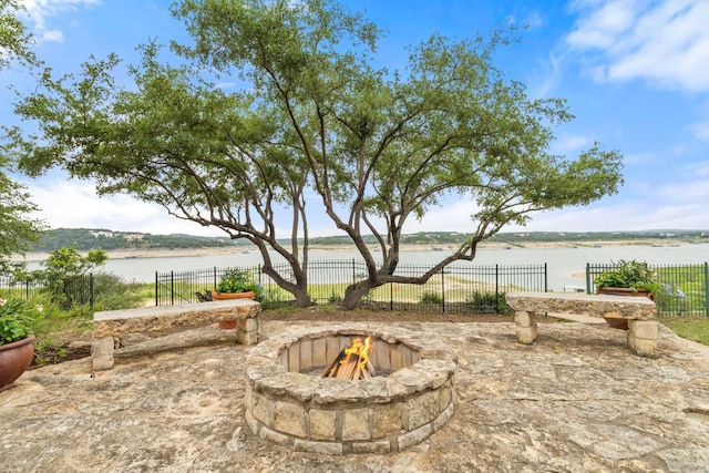 212 Lakefront Dr, Point Venture, TX 78645 - view of patio / terrace with a fire pit, fence, and a water view