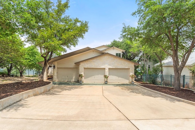 212 Lakefront Dr, Point Venture, TX 78645 - view of front of house featuring fence and stone siding