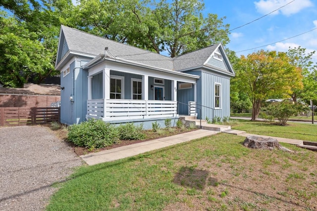 48 Chicon St, Austin, TX 78702 - view of front facade featuring a shingled roof, a porch, and board and batten siding
