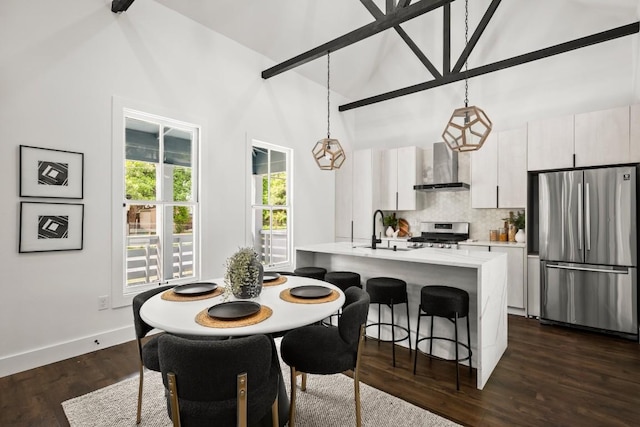 48 Chicon St, Austin, TX 78702 - dining space featuring dark wood-type flooring, high vaulted ceiling, and baseboards