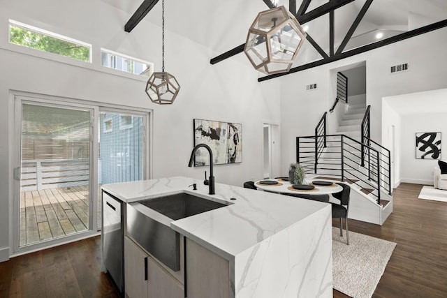 48 Chicon St, Austin, TX 78702 - kitchen with high vaulted ceiling, a sink, stainless steel dishwasher, dark wood-type flooring, and a center island with sink
