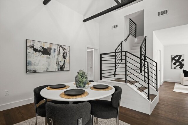 48 Chicon St, Austin, TX 78702 - dining area with stairs, a towering ceiling, wood finished floors, and baseboards