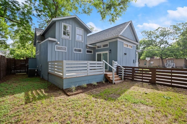 48 Chicon St, Austin, TX 78702 - back of property with board and batten siding, a fenced backyard, and roof with shingles
