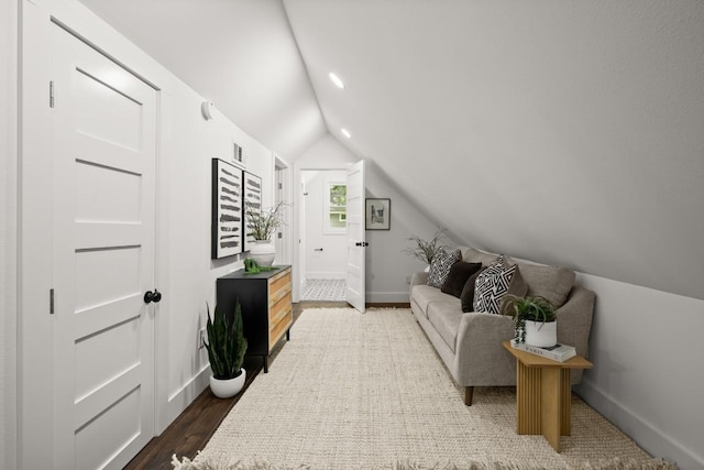 48 Chicon St, Austin, TX 78702 - living area featuring lofted ceiling, baseboards, and dark wood-type flooring