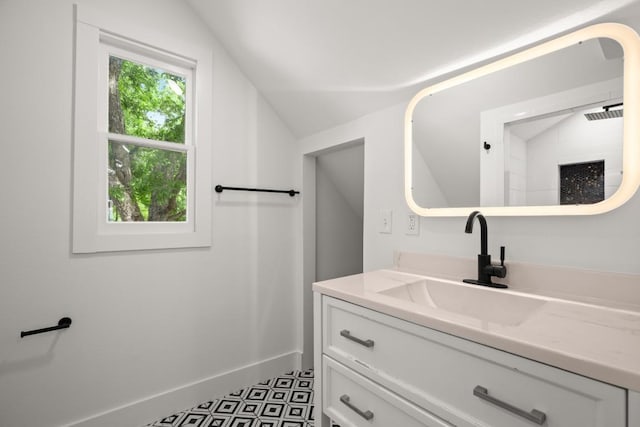 48 Chicon St, Austin, TX 78702 - bathroom with vanity, lofted ceiling, and baseboards
