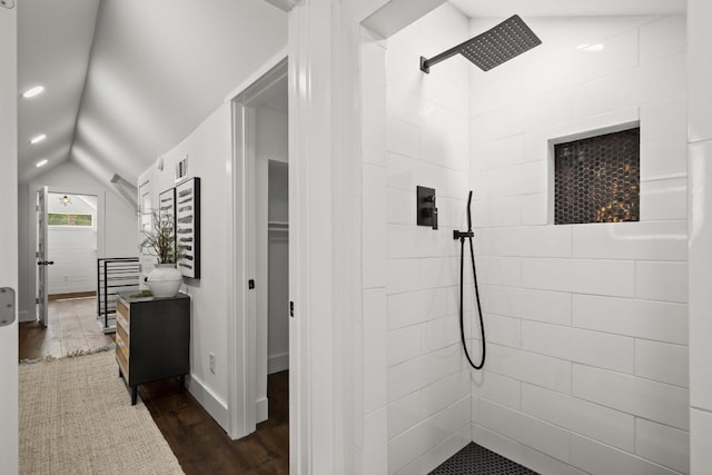 48 Chicon St, Austin, TX 78702 - full bathroom with a tile shower, wood finished floors, vaulted ceiling, and baseboards