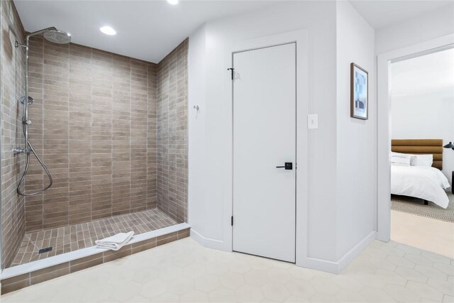 10226 Parsons Rd, Manor, TX 78653 - bathroom featuring tile patterned floors, recessed lighting, a tile shower, and ensuite bath