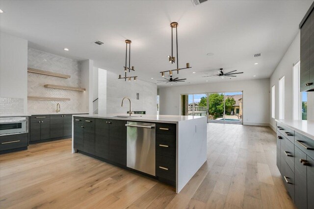 98 Wennmohs Pl, Horseshoe Bay, TX 78657 - kitchen with stainless steel dishwasher, a sink, modern cabinets, light countertops, and recessed lighting