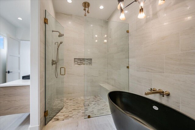 98 Wennmohs Pl, Horseshoe Bay, TX 78657 - bathroom featuring a soaking tub, a stall shower, and recessed lighting