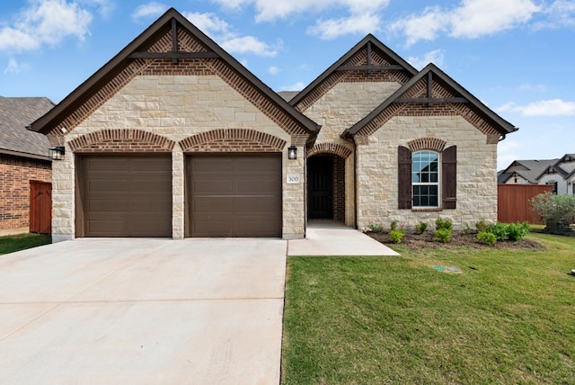 300 Barrel Bnd, Georgetown, TX 78628 - french country style house featuring a garage, driveway, and stone siding