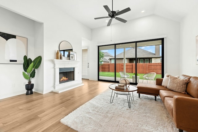 300 Barrel Bnd, Georgetown, TX 78628 - living area featuring wood finished floors, a warm lit fireplace, a ceiling fan, high vaulted ceiling, and recessed lighting