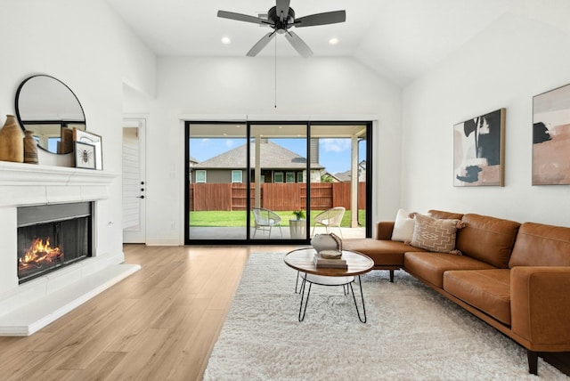 300 Barrel Bnd, Georgetown, TX 78628 - living area with wood finished floors, high vaulted ceiling, ceiling fan, a lit fireplace, and recessed lighting