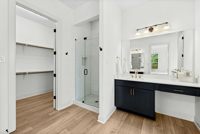 300 Barrel Bnd, Georgetown, TX 78628 - full bath with vanity, a spacious closet, a stall shower, and wood finished floors