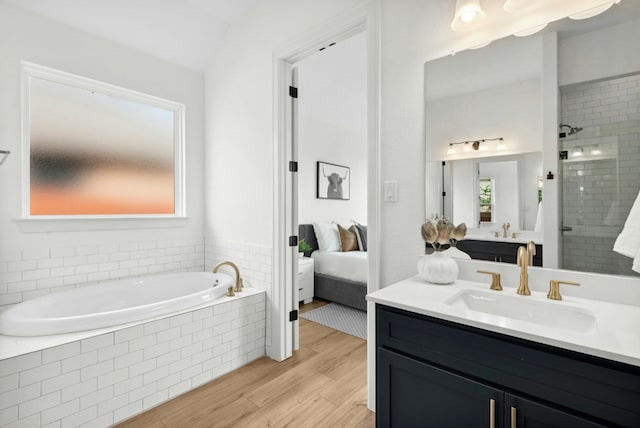 300 Barrel Bnd, Georgetown, TX 78628 - bathroom with ensuite bath, a bath, vanity, wood finished floors, and a stall shower
