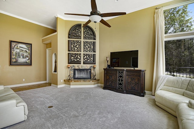 3211 Constitution Dr, Lago Vista, TX 78645 - living area with carpet flooring, a glass covered fireplace, ornamental molding, and a ceiling fan