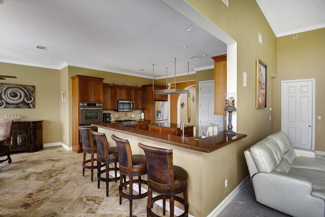 3211 Constitution Dr, Lago Vista, TX 78645 - kitchen with stainless steel appliances, a peninsula, dark countertops, open floor plan, and a kitchen breakfast bar