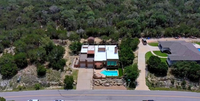 3211 Constitution Dr, Lago Vista, TX 78645 - aerial view of property and surrounding area featuring a pool area and a heavily wooded area